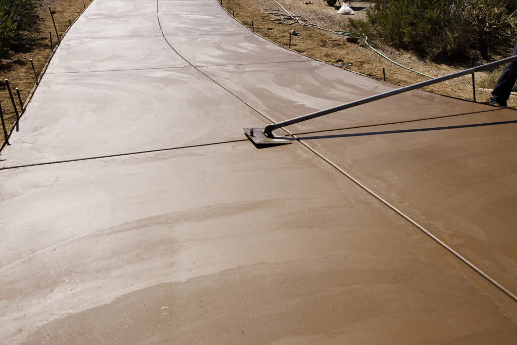 Worker smoothing concrete on a new driveway construction project | Schol's Concrete and Excavation Services, Chilliwack, British Columbia